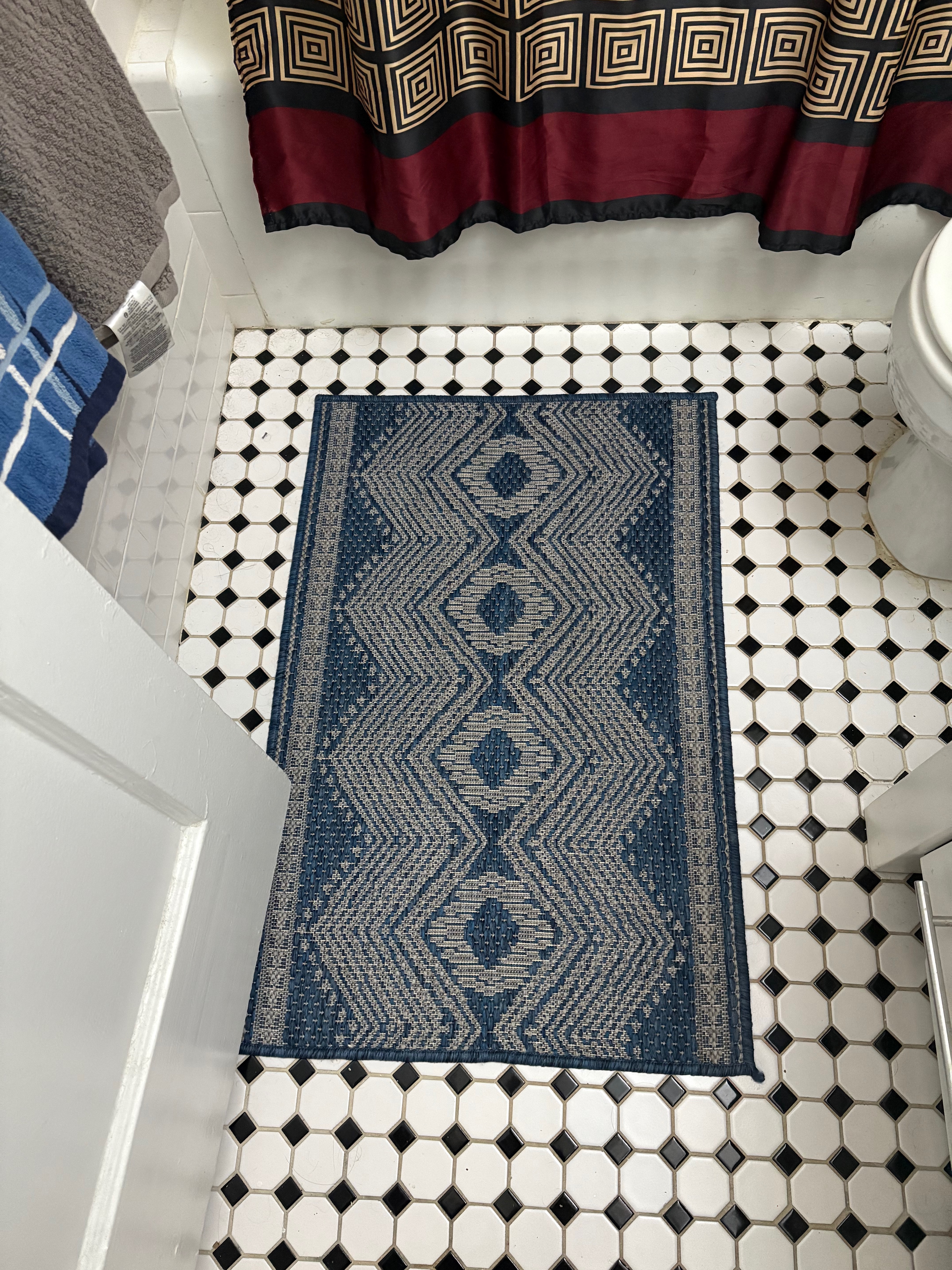 Bathroom rug, blue on top of tile