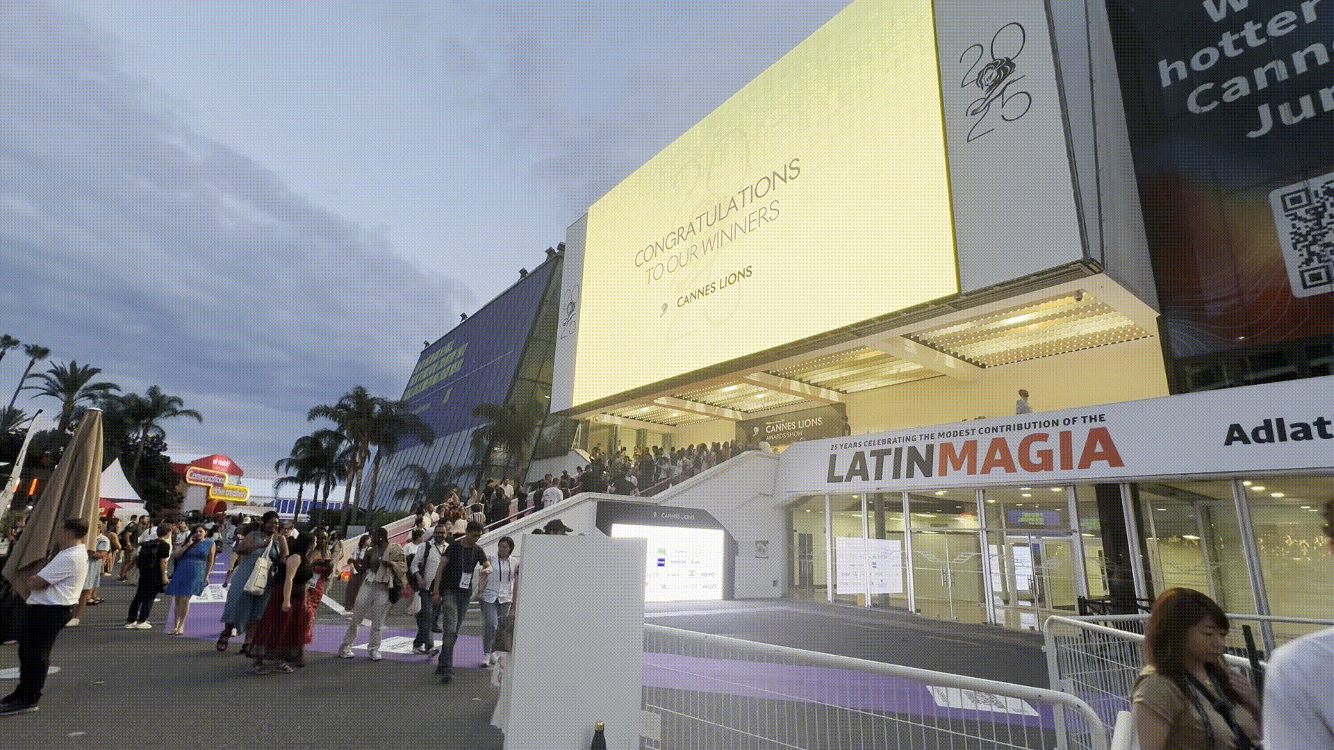 outside festival venue screen displaying “Congratulations to Our Winners”