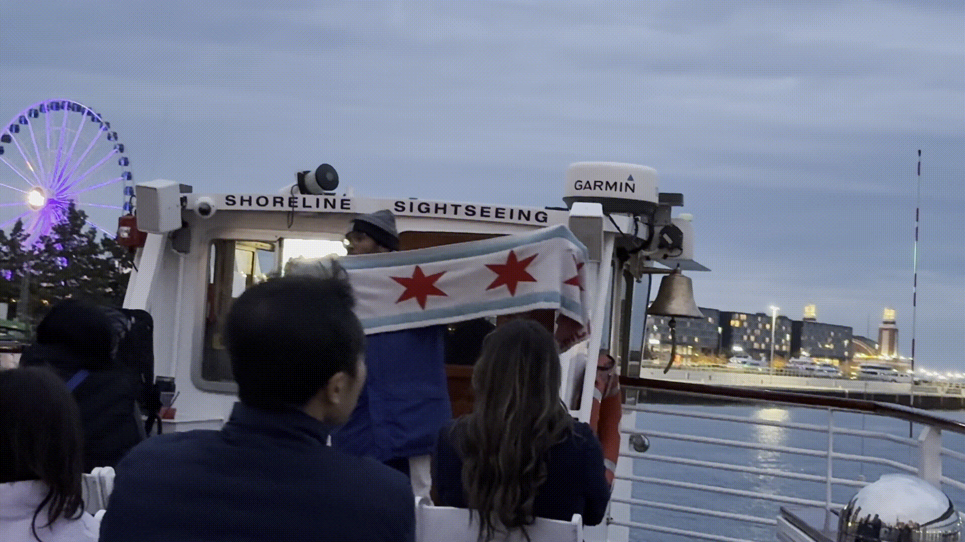 shoreline sightseeing guide holding a Chicago flag scarf