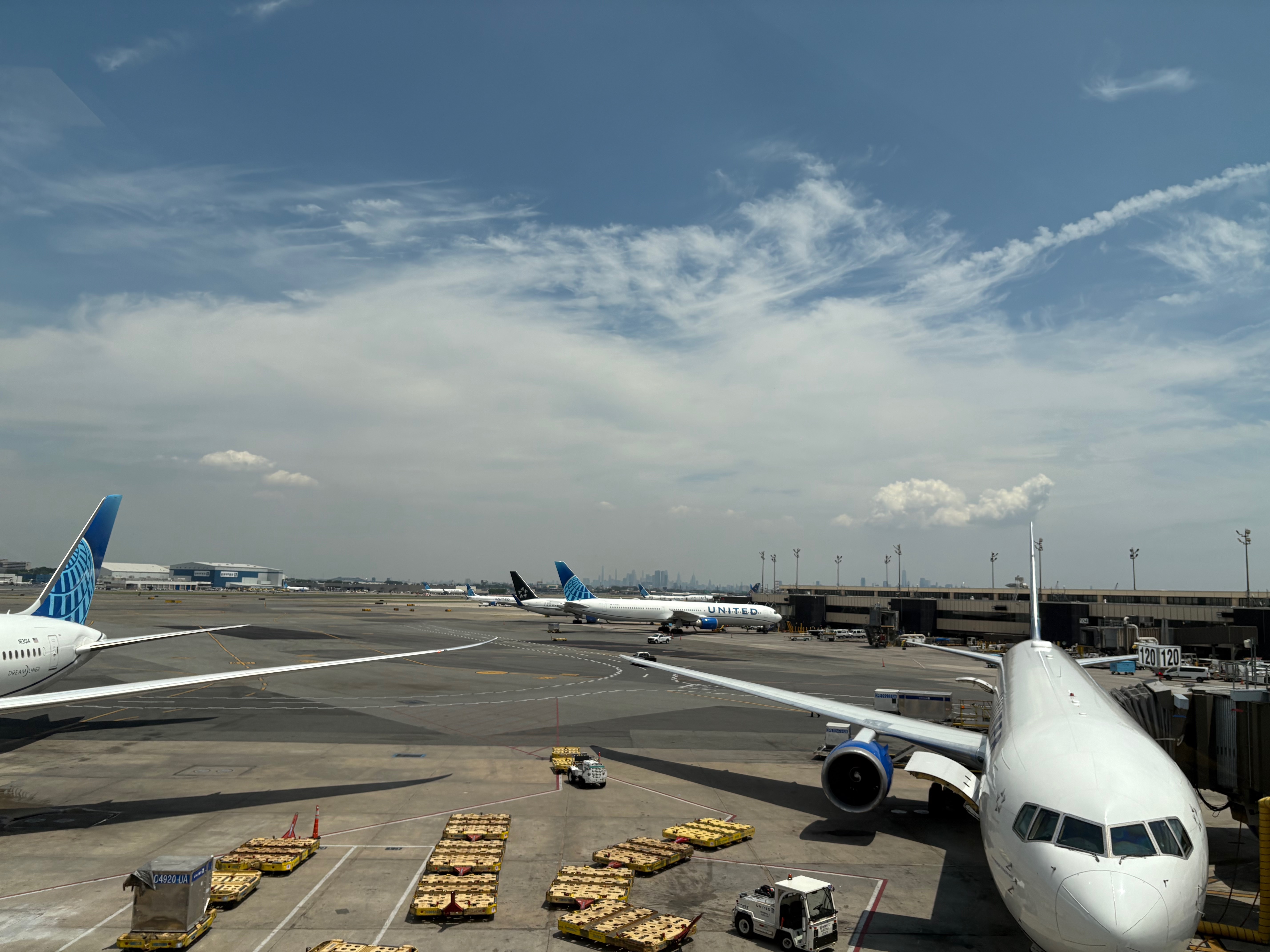 view from Newark airport towards Manhattan, skyscrapers in the distance, planes in the foreground